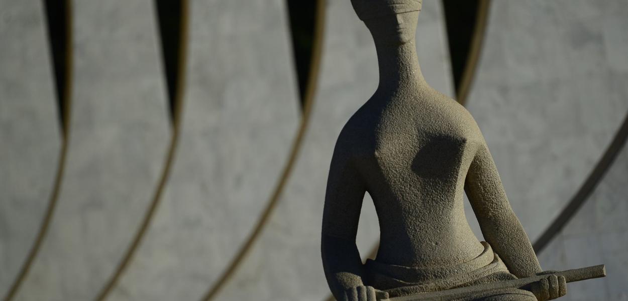 Jurista negra revisa decisão judicial, corrigindo erros e garantindo justiça.
