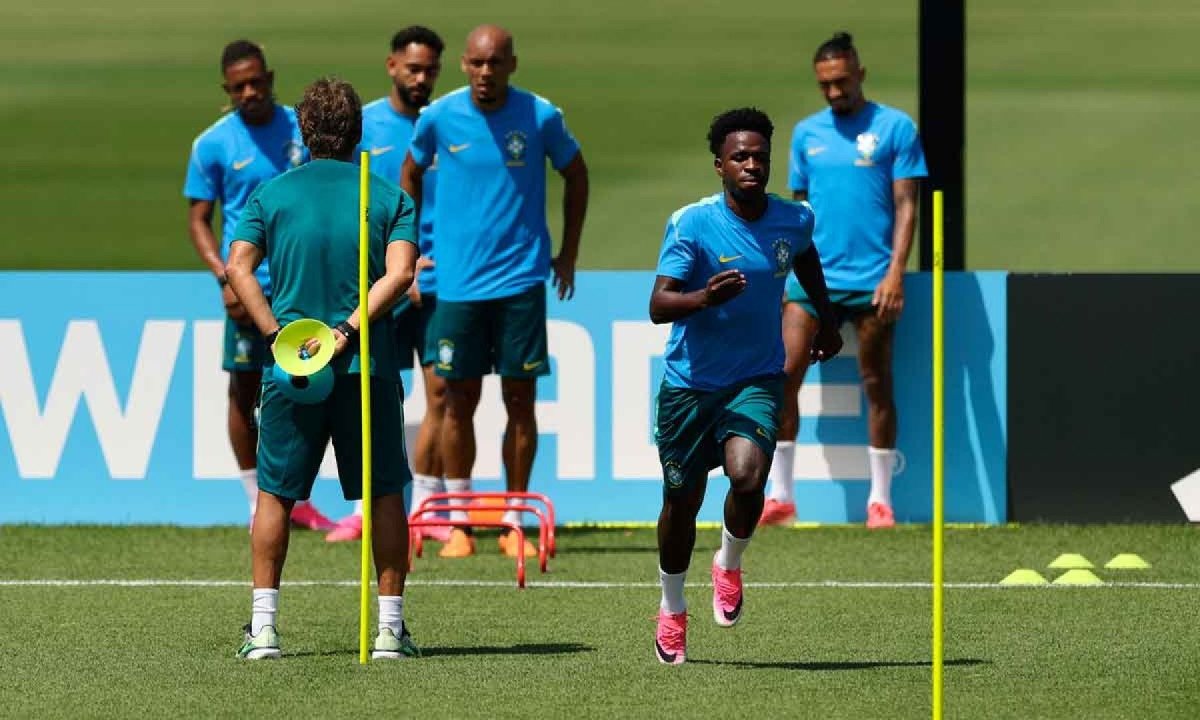 Time brasileiro comemora vitória no hexagonal, com jogadores reunidos em torno da bandeira.